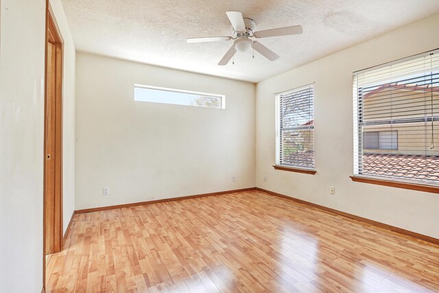 8300 R C Gorman Ave NE, Albuquerque, NM 87122 - spare room with light wood-type flooring, a textured ceiling, and a ceiling fan