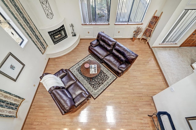 8300 R C Gorman Ave NE, Albuquerque, NM 87122 - living area featuring healthy amount of natural light, wood finished floors, and a fireplace with raised hearth