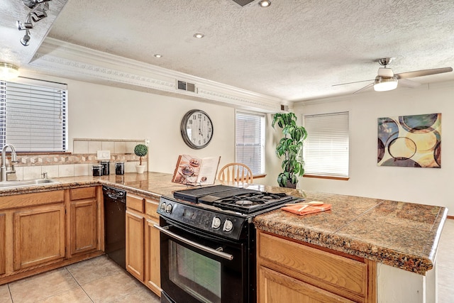 8300 R C Gorman Ave NE, Albuquerque, NM 87122 - kitchen featuring tile counters, black appliances, a peninsula, crown molding, and ceiling fan