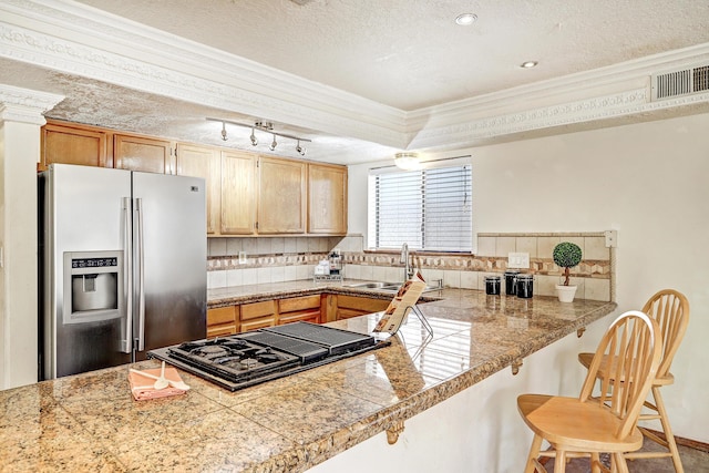 8300 R C Gorman Ave NE, Albuquerque, NM 87122 - kitchen featuring stainless steel fridge with ice dispenser, tile countertops, ornamental molding, black gas stovetop, and tasteful backsplash