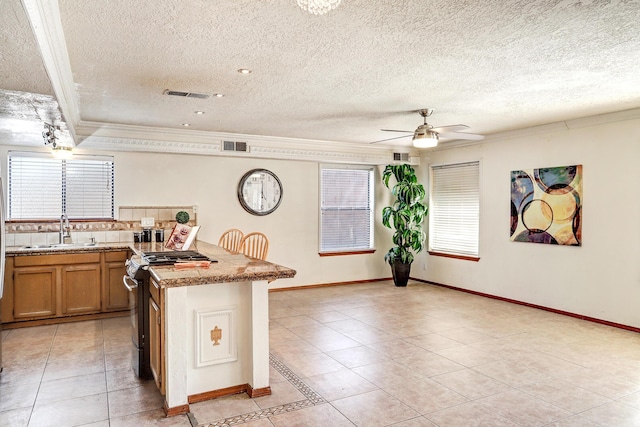 8300 R C Gorman Ave NE, Albuquerque, NM 87122 - kitchen featuring ornamental molding, light tile patterned flooring, range, a ceiling fan, and backsplash