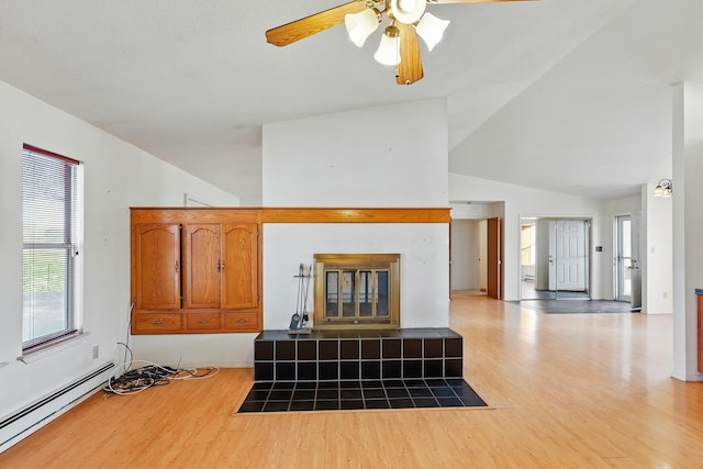 living room featuring a baseboard radiator, light wood-style floors, vaulted ceiling, and a ceiling fan
