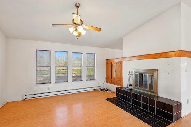 unfurnished living room featuring a baseboard radiator, wood finished floors, a ceiling fan, and a tile fireplace