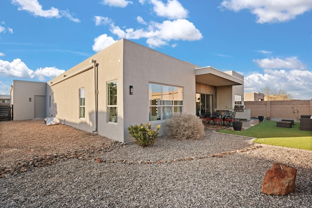 8023 Victoria Dr NW, Albuquerque, NM 87120 - rear view of property featuring fence, stucco siding, and a patio area