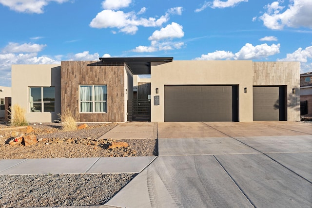 8023 Victoria Dr NW, Albuquerque, NM 87120 - view of front of house featuring a garage, stucco siding, and driveway