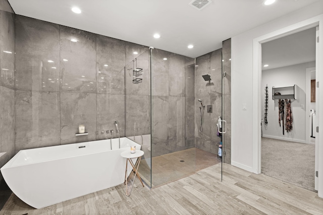 8023 Victoria Dr NW, Albuquerque, NM 87120 - full bath featuring visible vents, a stall shower, wood finished floors, a soaking tub, and recessed lighting