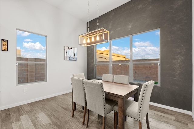 8023 Victoria Dr NW, Albuquerque, NM 87120 - dining room with baseboards, an inviting chandelier, and wood finished floors