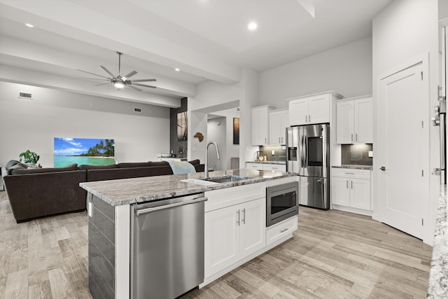 8023 Victoria Dr NW, Albuquerque, NM 87120 - kitchen with a sink, an island with sink, a ceiling fan, light wood-style flooring, and stainless steel appliances
