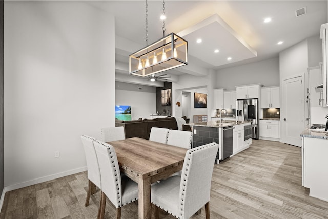 8023 Victoria Dr NW, Albuquerque, NM 87120 - dining room featuring visible vents, a towering ceiling, light wood-style floors, recessed lighting, and a ceiling fan