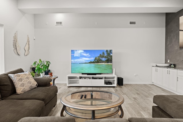 8023 Victoria Dr NW, Albuquerque, NM 87120 - living room featuring baseboards, light wood-type flooring, and visible vents