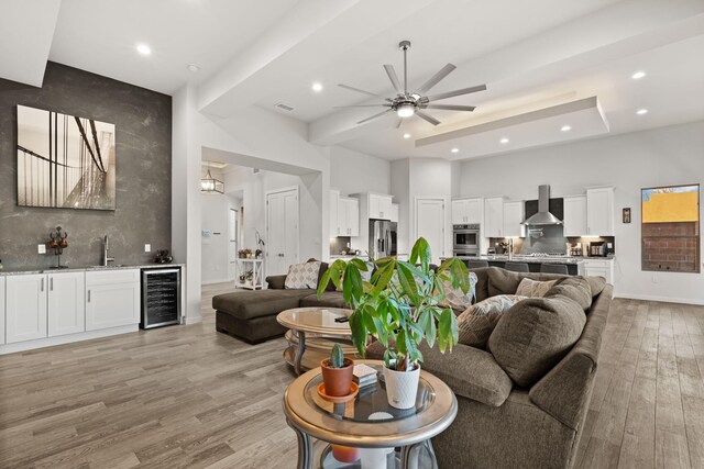 8023 Victoria Dr NW, Albuquerque, NM 87120 - living room with beverage cooler, indoor wet bar, ceiling fan, recessed lighting, and light wood-type flooring