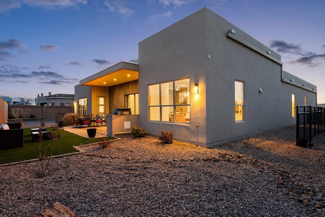 8023 Victoria Dr NW, Albuquerque, NM 87120 - rear view of property with fence, stucco siding, and a patio area