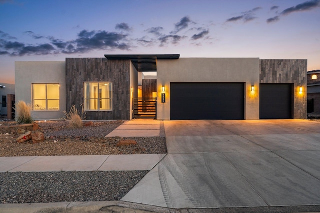 8023 Victoria Dr NW, Albuquerque, NM 87120 - contemporary home with an attached garage, driveway, and stucco siding
