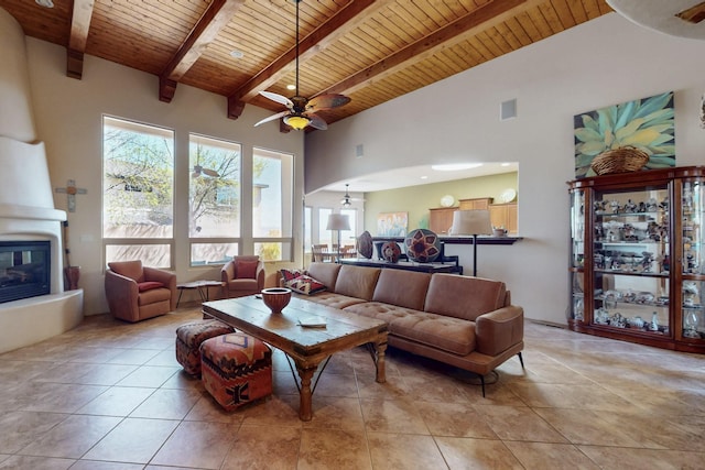 9840 Cameron St NW, Albuquerque, NM 87114 - living room with a ceiling fan, wood ceiling, light tile patterned floors, and a fireplace