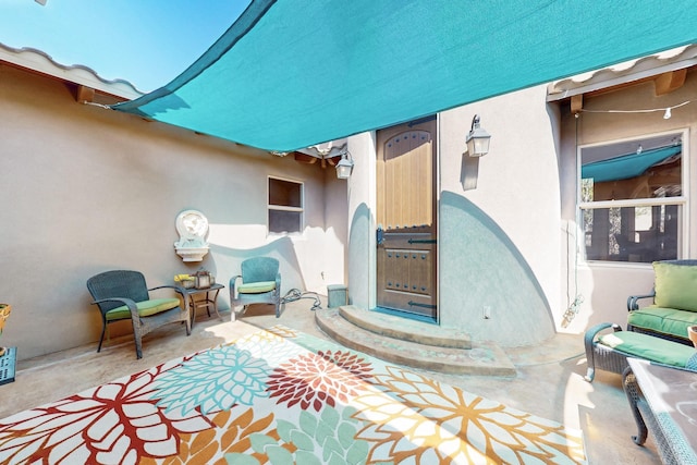 9840 Cameron St NW, Albuquerque, NM 87114 - view of exterior entry featuring a patio area and stucco siding