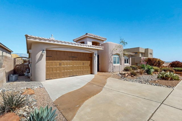 9840 Cameron St NW, Albuquerque, NM 87114 - view of front facade featuring a garage, stucco siding, driveway, and a tile roof