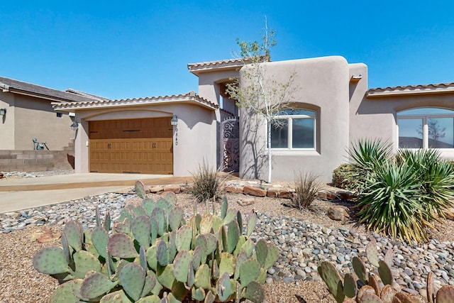 9840 Cameron St NW, Albuquerque, NM 87114 - view of front of home featuring a garage, stucco siding, and a tile roof