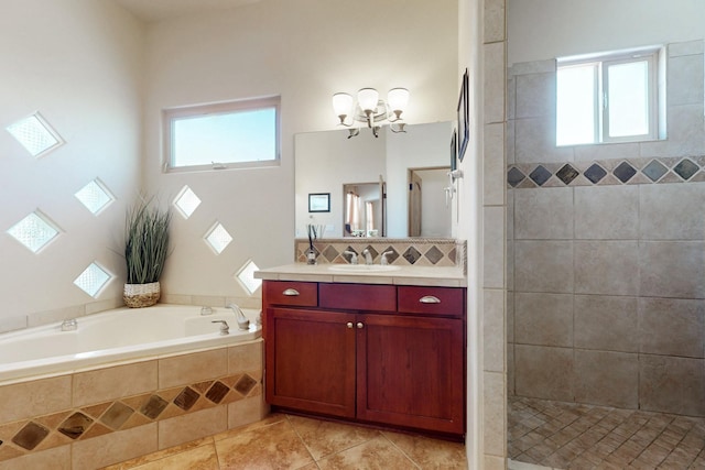 9840 Cameron St NW, Albuquerque, NM 87114 - bathroom with tiled shower, a healthy amount of sunlight, tile patterned flooring, and vanity