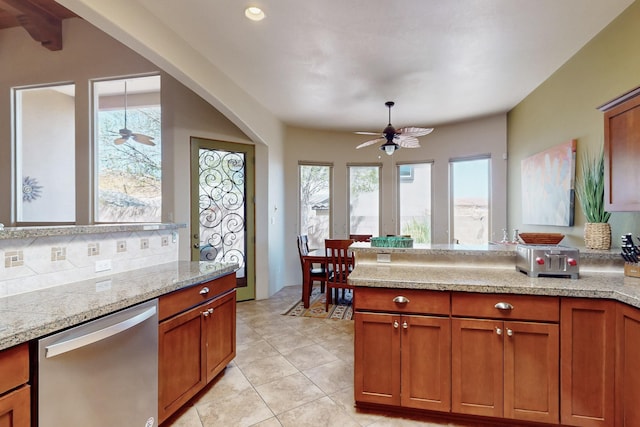 9840 Cameron St NW, Albuquerque, NM 87114 - kitchen with a peninsula, light tile patterned floors, brown cabinets, a ceiling fan, and dishwasher