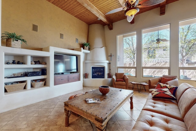 9840 Cameron St NW, Albuquerque, NM 87114 - tiled living room featuring ceiling fan, a wealth of natural light, and wooden ceiling