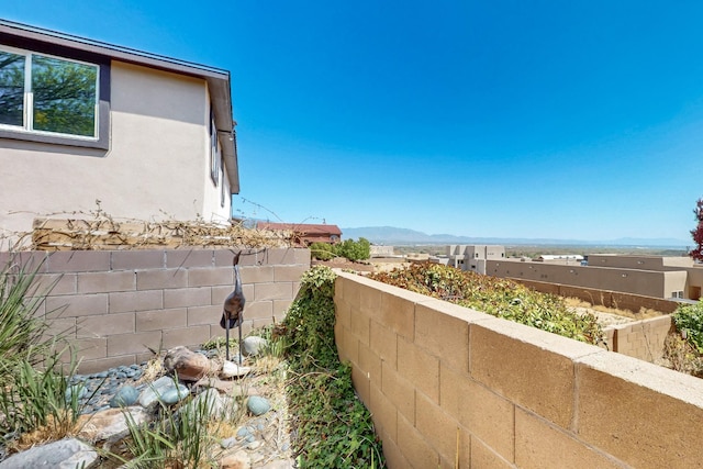 9840 Cameron St NW, Albuquerque, NM 87114 - exterior space with stucco siding, a mountain view, and fence