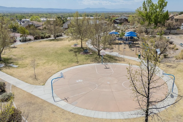 9840 Cameron St NW, Albuquerque, NM 87114 - exterior space with community basketball court, a mountain view, and a yard