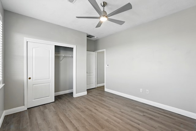 7327 Hearthstone Rd NW, Albuquerque, NM 87114 - unfurnished bedroom featuring wood finished floors, baseboards, a closet, and ceiling fan