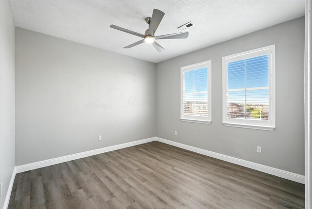 7327 Hearthstone Rd NW, Albuquerque, NM 87114 - spare room with dark wood-type flooring, a ceiling fan, and baseboards