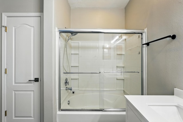 7327 Hearthstone Rd NW, Albuquerque, NM 87114 - bathroom featuring combined bath / shower with glass door and vanity