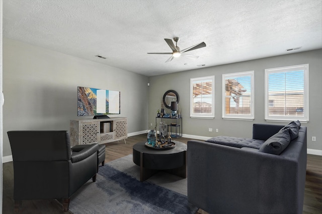 7327 Hearthstone Rd NW, Albuquerque, NM 87114 - living room with dark wood-style floors, a ceiling fan, baseboards, and a textured ceiling