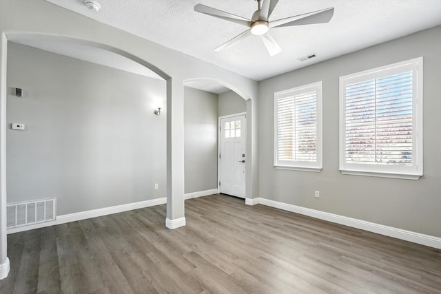 7327 Hearthstone Rd NW, Albuquerque, NM 87114 - entrance foyer with arched walkways, ceiling fan, wood finished floors, and baseboards