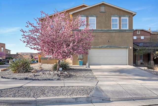 7327 Hearthstone Rd NW, Albuquerque, NM 87114 - view of front facade with stucco siding, an attached garage, and concrete driveway