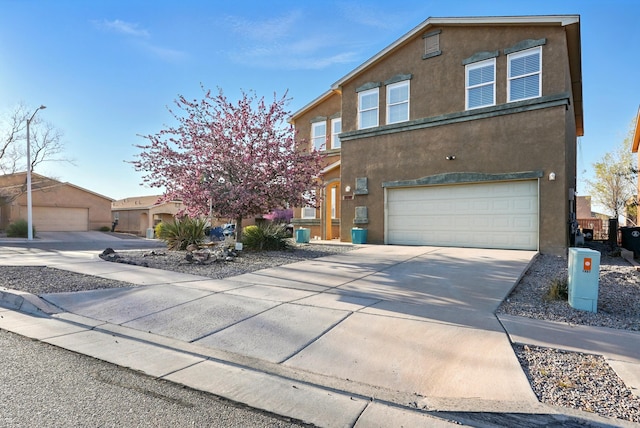 7327 Hearthstone Rd NW, Albuquerque, NM 87114 - view of front facade with a garage, stucco siding, and driveway