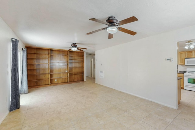 spare room featuring baseboards, built in features, ceiling fan, and light tile patterned flooring