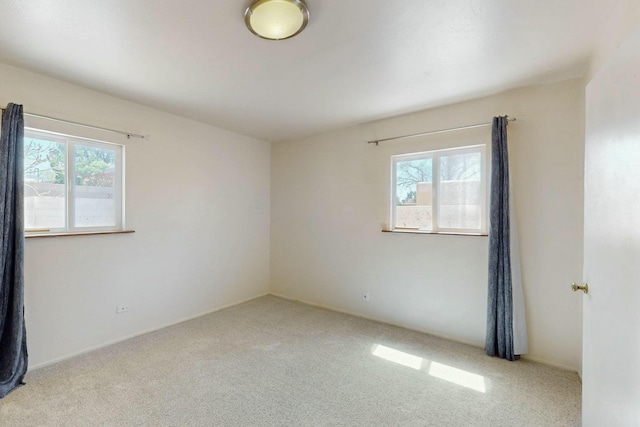 carpeted spare room with plenty of natural light
