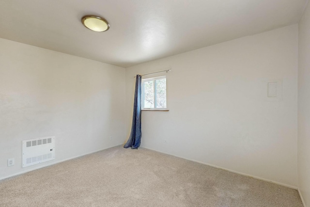 carpeted spare room with baseboards and visible vents