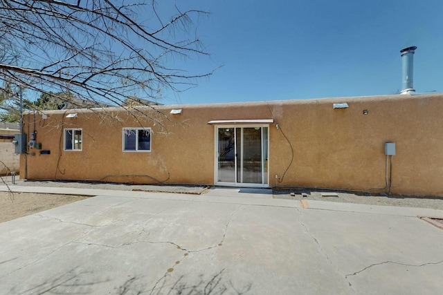 back of house with stucco siding