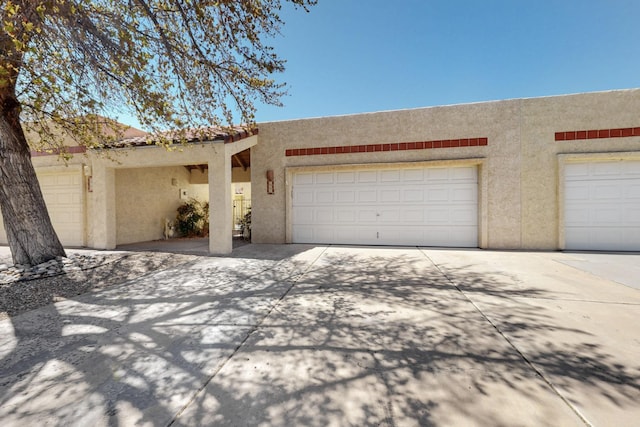 garage with concrete driveway