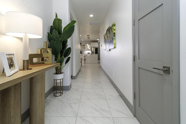 hall featuring marble finish floor, baseboards, visible vents, and recessed lighting