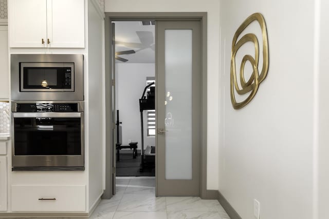 interior space featuring marble finish floor and baseboards