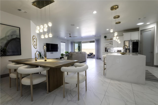 dining area featuring recessed lighting, visible vents, marble finish floor, and ceiling fan with notable chandelier