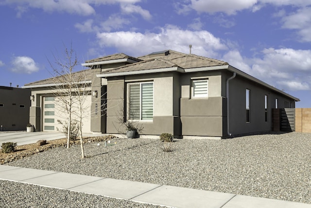 exterior space with a garage, driveway, and stucco siding