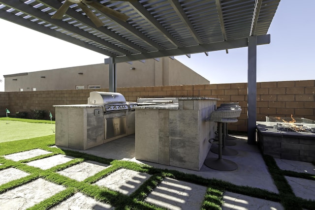 view of patio / terrace with a fire pit, a pergola, area for grilling, grilling area, and fence