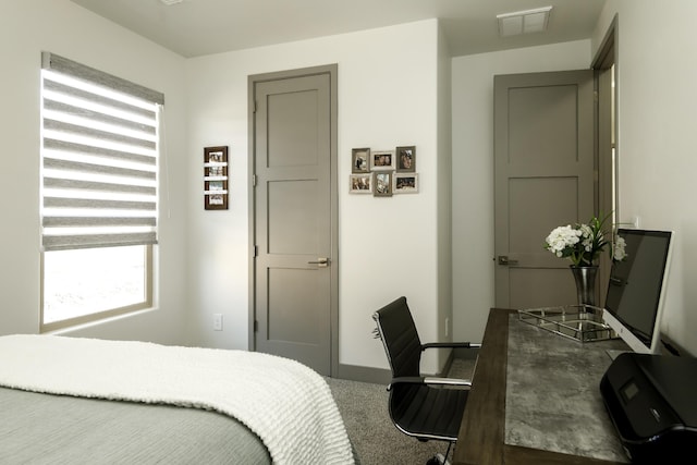 bedroom with carpet flooring, baseboards, and visible vents