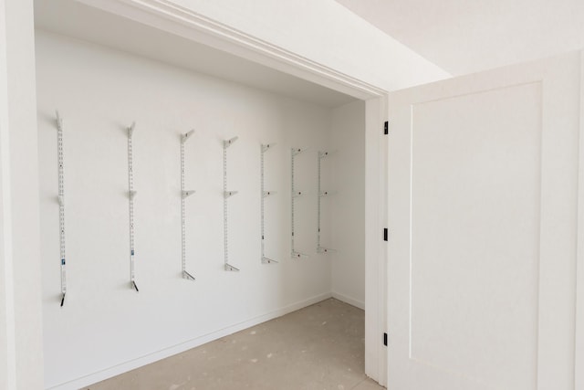 interior space featuring baseboards and concrete floors