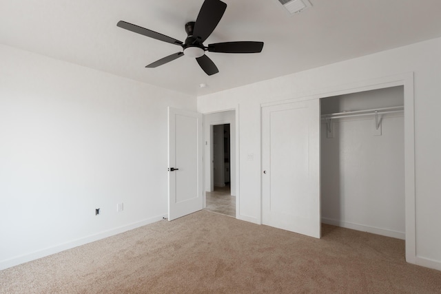 unfurnished bedroom featuring visible vents, carpet floors, a closet, baseboards, and ceiling fan