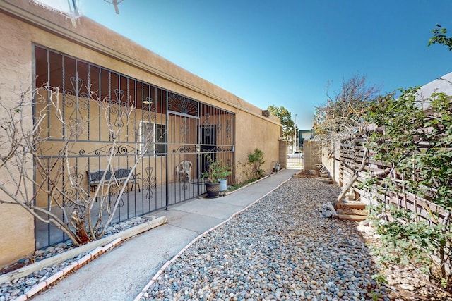 12522 Singing Arrow Ave SE, Albuquerque, NM 87123 - view of side of home featuring fence and a gate