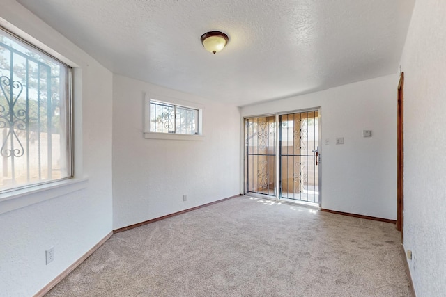 12522 Singing Arrow Ave SE, Albuquerque, NM 87123 - empty room featuring baseboards, a textured ceiling, and carpet floors