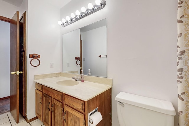 12522 Singing Arrow Ave SE, Albuquerque, NM 87123 - bathroom with toilet, tile patterned floors, and vanity