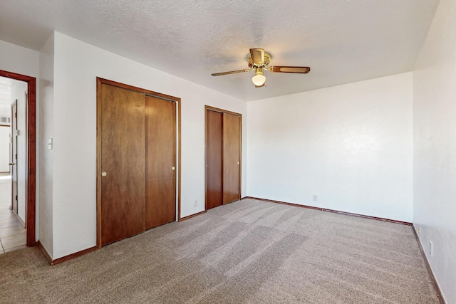 12522 Singing Arrow Ave SE, Albuquerque, NM 87123 - unfurnished bedroom with carpet flooring, baseboards, and multiple closets